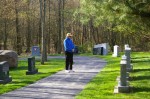 Marine Corps Veteran Ted Driscol of Amherst stands in front of one of the many memorial stones in the Western Reserve National Cemetery